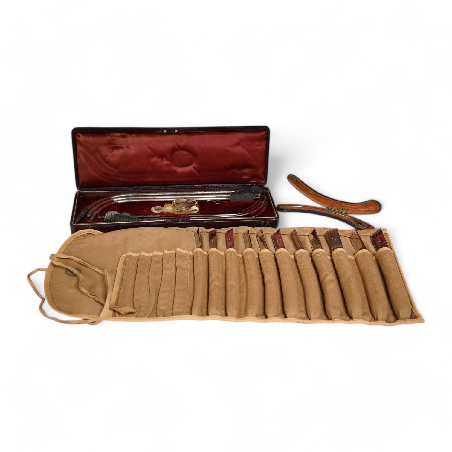 A late 19th century leather cased medical set of catheter surgical instruments, together with a single leather case catheter, plus an early 20th century canvas roll containing a graduated set of gynaecological surgical i